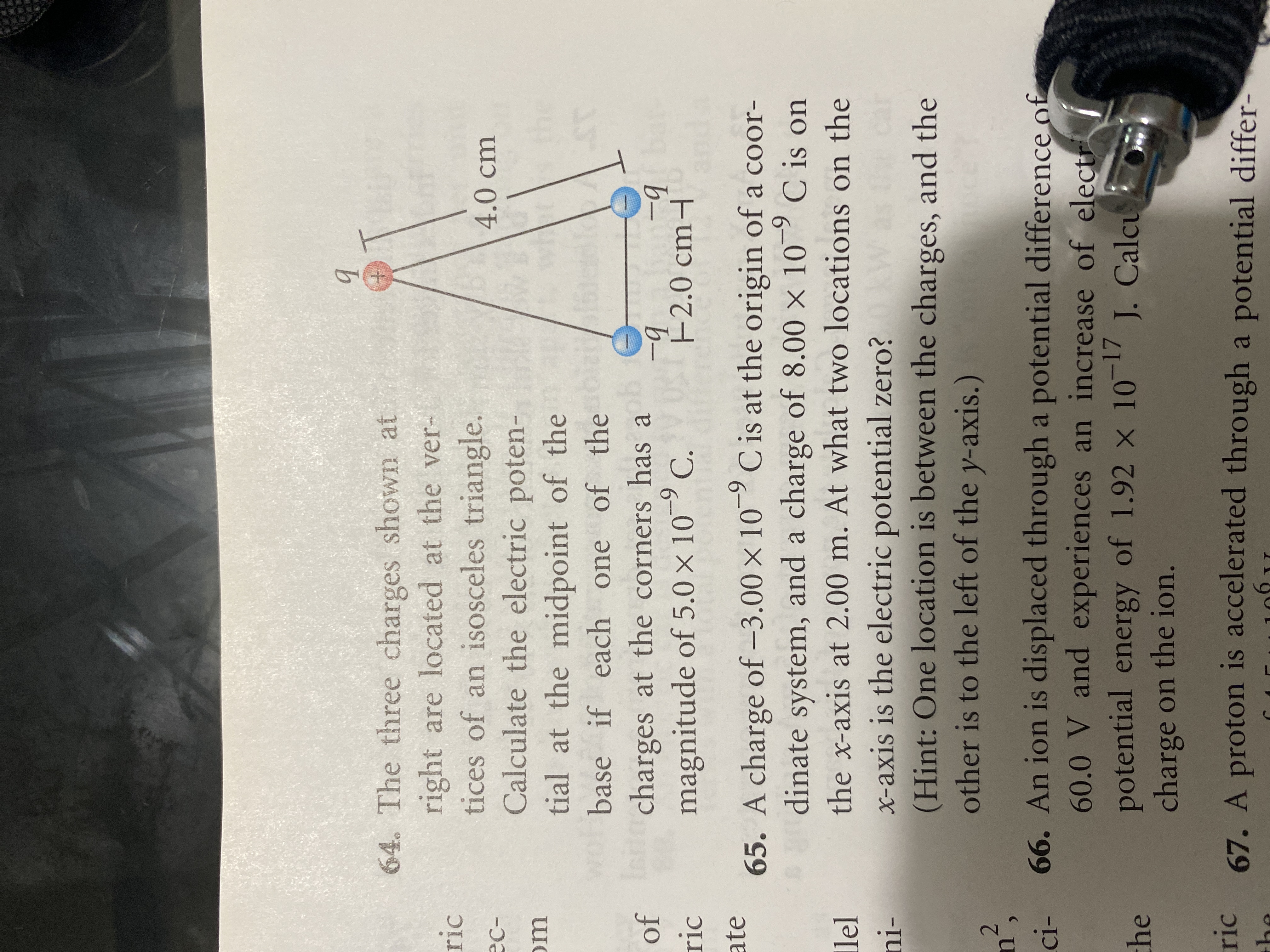 64. The three charges shown at
right are located at the ver-
tices of an isosceles triangle.
Calculate the electric poten-
4.0 cm
tial at the midpoint of the
16
base if each one of the
Ini
Iericharges at the corners has a
-9
-9
F2.0 cm-
magnitude of 5.0 × 10 C.
