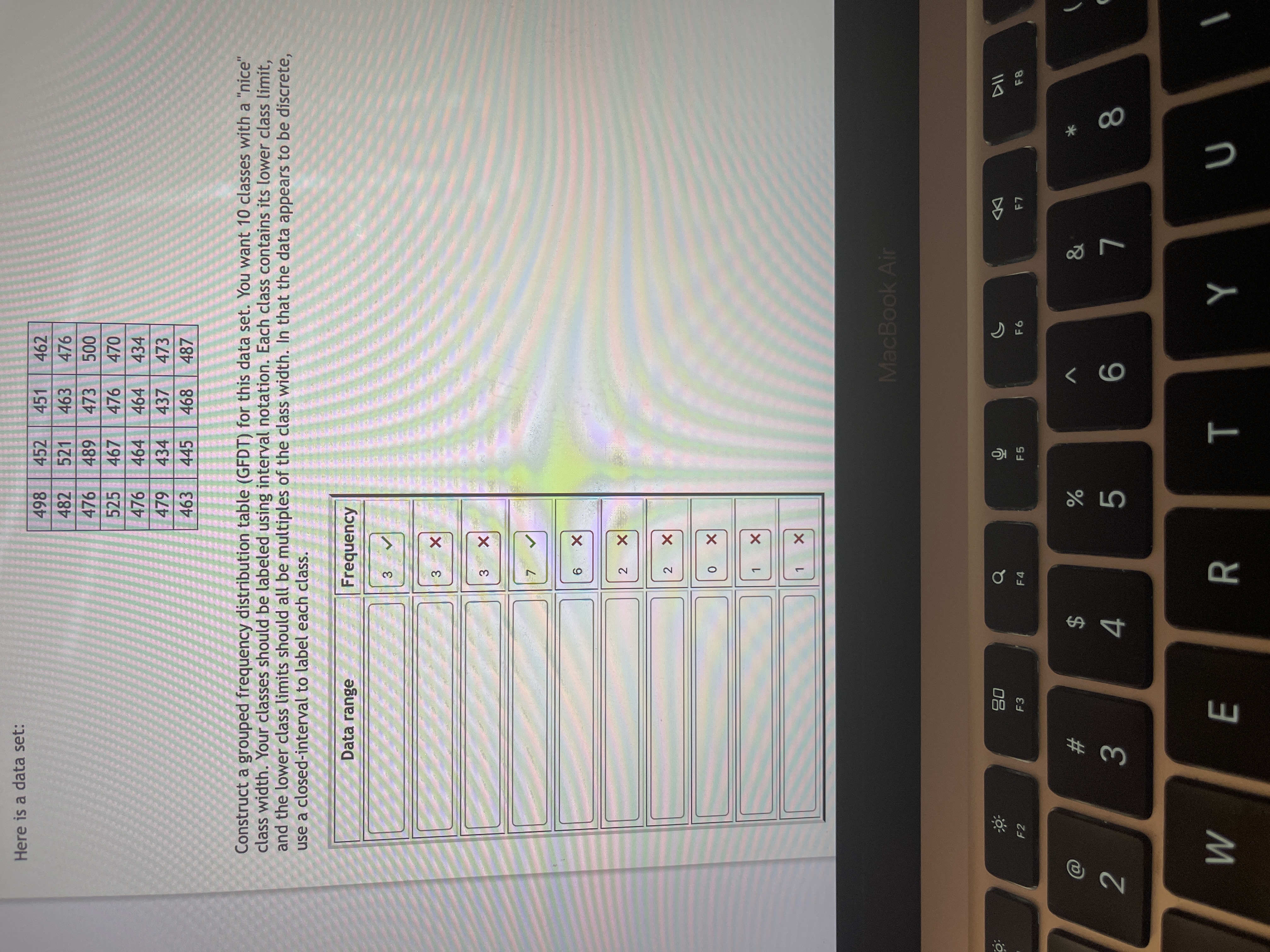 ### Educational Website Transcription and Explanation

#### Data Set
Here is a data set:
```
498, 452, 451, 462
482, 521, 463, 476
476, 489, 473, 500
525, 467, 476, 470
476, 464, 464, 434
463, 441, 437, 473
463, 445, 468, 487
```

#### Task
Construct a grouped frequency distribution table (GFDT) for this data set. You need to create 10 classes with a "nice" class width. Classes should be labeled using interval notation. Each class contains its lower class limit, and the lower class limits should be multiples of the class width. Since the data appears to be discrete, use a closed interval to label each class.

#### Grouped Frequency Distribution Table (GFDT)
The table consists of two columns: "Data range" and "Frequency."

| Data Range | Frequency |
|------------|-----------|
| [430, 440] | 3 ✔️       |
| [440, 450] | 3 ❌       |
| [450, 460] | 3 ❌       |
| [460, 470] | 7 ✔️       |
| [470, 480] | 6 ✔️       |
| [480, 490] | 2 ❌       |
| [490, 500] | 0 ❌       |
| [500, 510] | 1 ❌       |
| [510, 520] | 1 ❌       |

#### Explanation
- **Data Range**: Represents intervals of the data set, structured in a way that each interval is a multiple of the class width.
- **Frequency**: Indicates how many data points fall into each interval.
- "✔️" and "❌" symbols demonstrate correct and incorrect entries respectively for the class intervals based on given criteria.
  
This table helps visualize the distribution of data points across different intervals, aiding in understanding the data's spread and concentration.