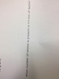 What number of atoms is present in 4.9 mol of NaOH?
