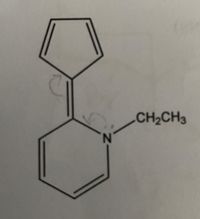 The image depicts the structural formula of a chemical compound. The compound consists of two connected aromatic rings and an ethyl group.

1. **Structural Details:**
   - The first ring is a five-membered aromatic ring (possibly a pyrrole or similar heterocycle) with alternating double bonds.
   - The second ring is a six-membered aromatic benzene ring (phenyl group) with alternating double bonds.
   - The two rings are connected by a shared bond, forming a bicyclic structure.
   - An ethyl group (CH₂CH₃) is attached to a nitrogen atom (N) within the five-membered ring.

2. **Bonding and Connectivity:**
   - The five-membered ring includes nitrogen within its structure, making it a heterocyclic aromatic ring.
   - Arrows near the nitrogen suggest electron delocalization or potential resonance within the structure.

This structural formula is an example of a nitrogen-containing bicyclic compound that might be studied in advanced organic chemistry courses, emphasizing aromaticity and resonance in heterocycles.