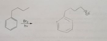 The image depicts a chemical reaction illustrating the bromination of an alkylbenzene under the influence of light.

**Structure Before Reaction:**
- On the left, a benzene ring (an aromatic six-membered carbon ring with alternating double bonds) is connected to a three-carbon straight chain (propyl group).

**Reaction Conditions:**
- The reaction is carried out using bromine (\( \text{Br}_2 \)) under ultraviolet light (\( hv \)).

**Structure After Reaction:**
- On the right, the resulting structure shows the benzene ring connected to a three-carbon chain, where the terminal carbon now bears a bromine atom (\( \text{Br} \)).

**Explanation:**
This reaction is an example of photochemical free radical bromination, where the presence of light initiates the formation of bromine radicals that substitute a hydrogen atom in the alkyl chain with a bromine atom. This specific reaction features the addition of a bromine atom at the end of the propyl side chain attached to the benzene ring.